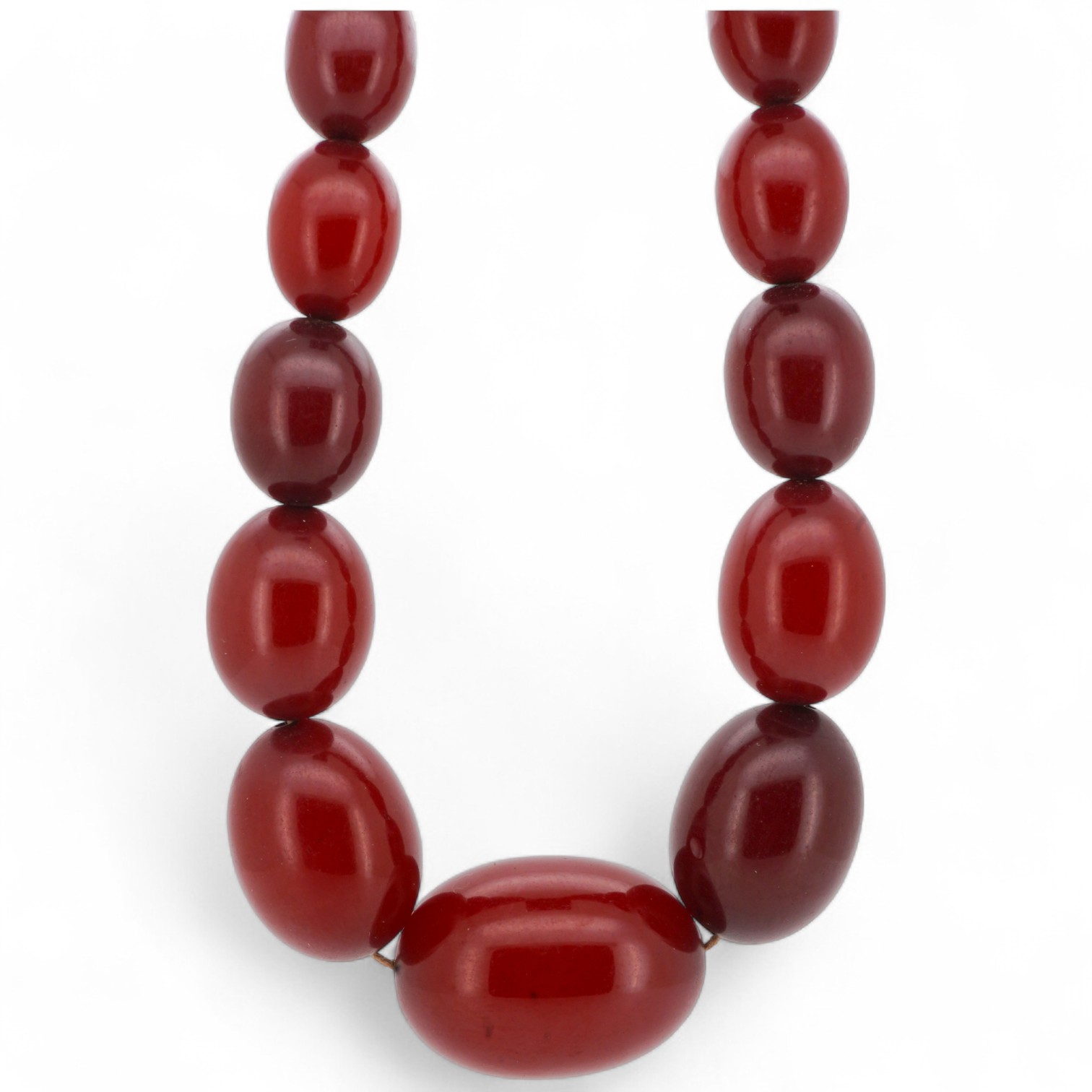 A cherry-coloured bakelite simulant amber necklace, composed of graduated beads measuring approximately 8-28mm, length 86cm, gross weight approximately 61 grams